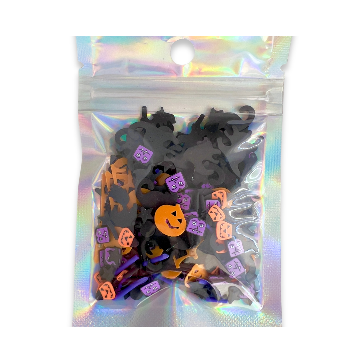 A clear holographic zip-top bag filled with small Halloween-themed charms, including black bat silhouettes, orange jack-o'-lanterns,l, shown on a white background.